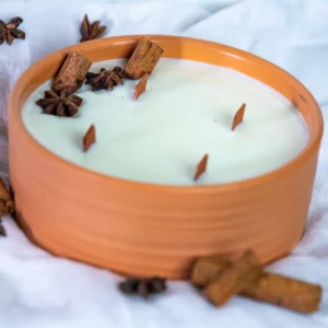 Scented candle in a clay jar